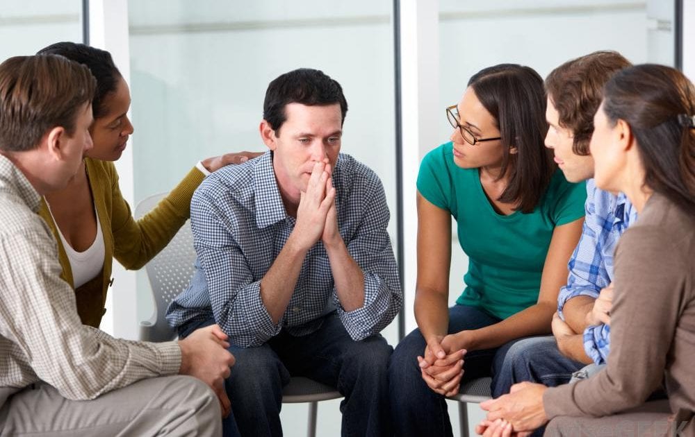 man-talking-with-small-group